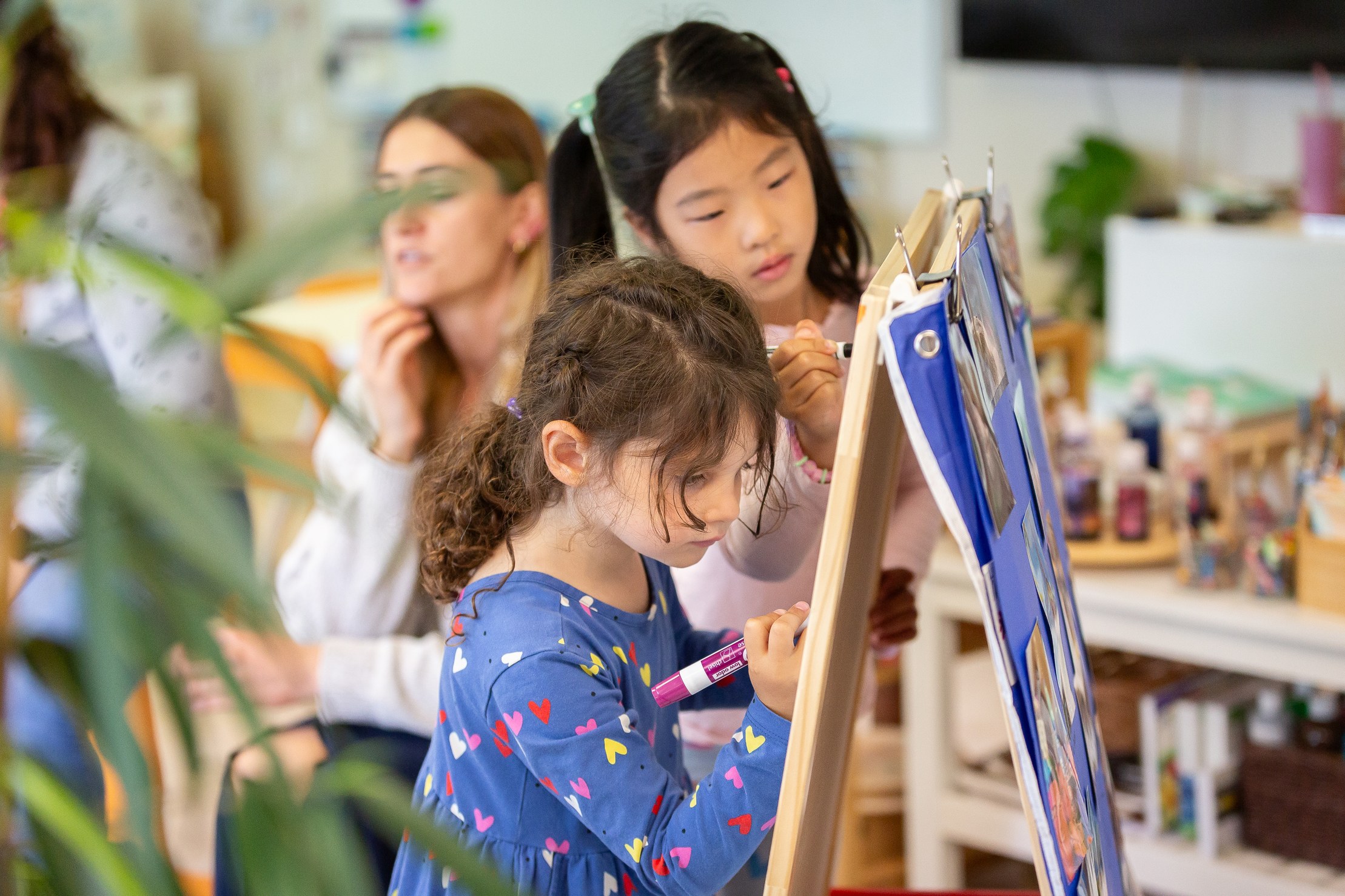 Elementary students working together in a sunlit classroom