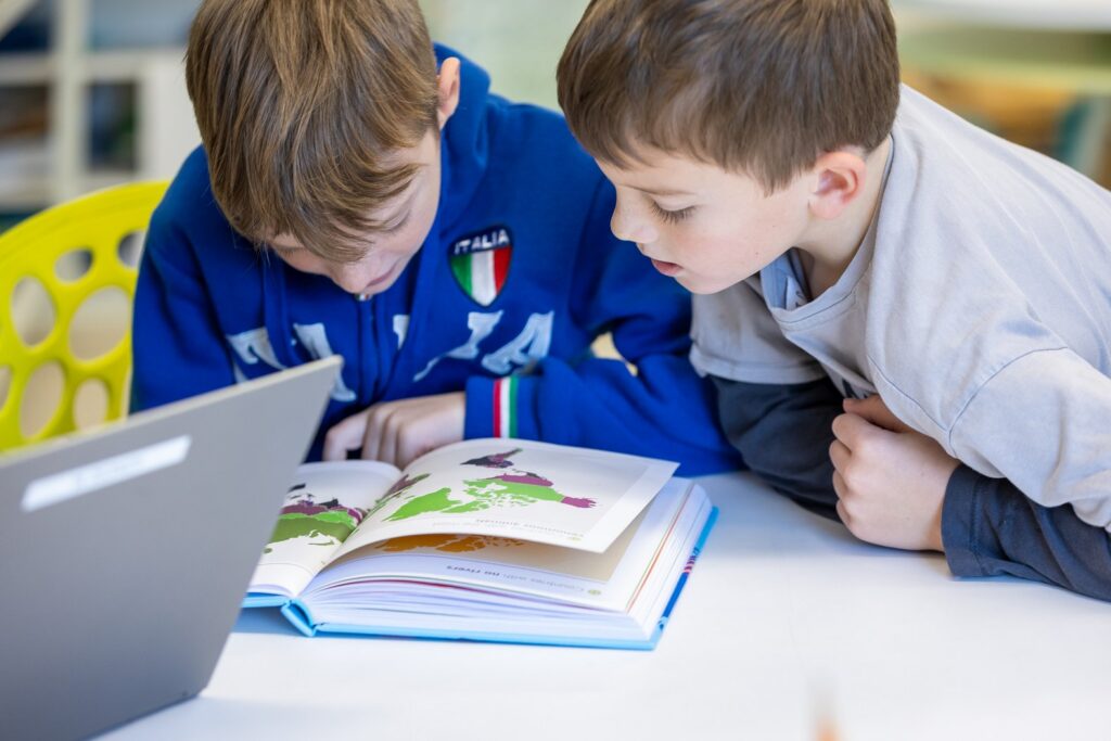 Students studying a large map of Italy